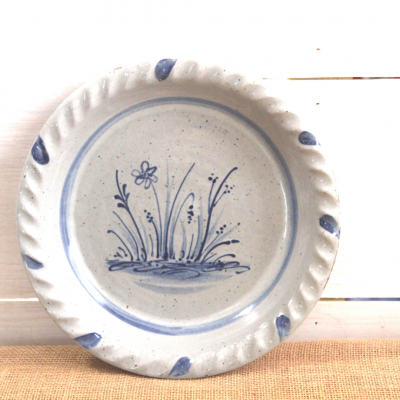                Handcrafted Rowe Pottery pie plate with a hand decorated seasonal wildflower design             