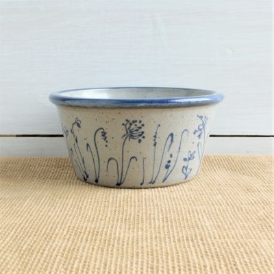               hand thrown wildflower design bowl with shiplap background              