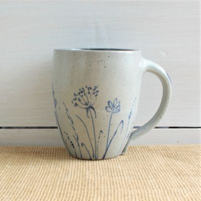                          wheel thrown cafe mug with spring wildflower pattern on a shiplap background