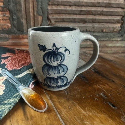                          wheel thrown cafe mug with spring wildflower pattern on a shiplap background